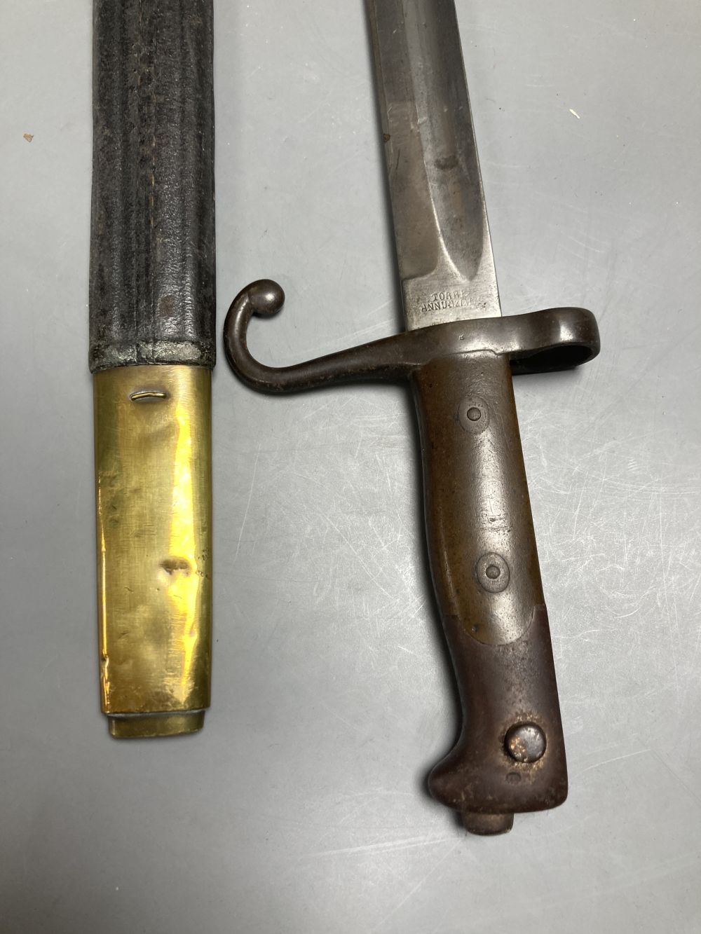 An Italian Torre Annunziata bayonet, 51cm blade, within leather and brass scabbard